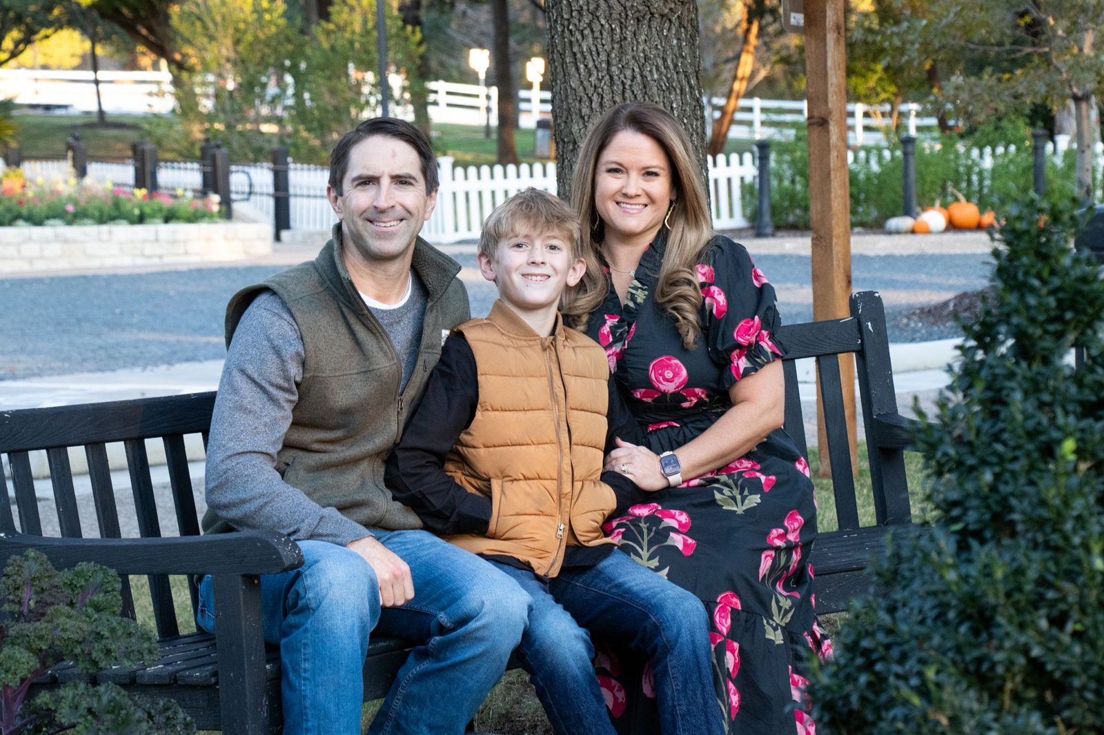 Family sitting together on a park bench